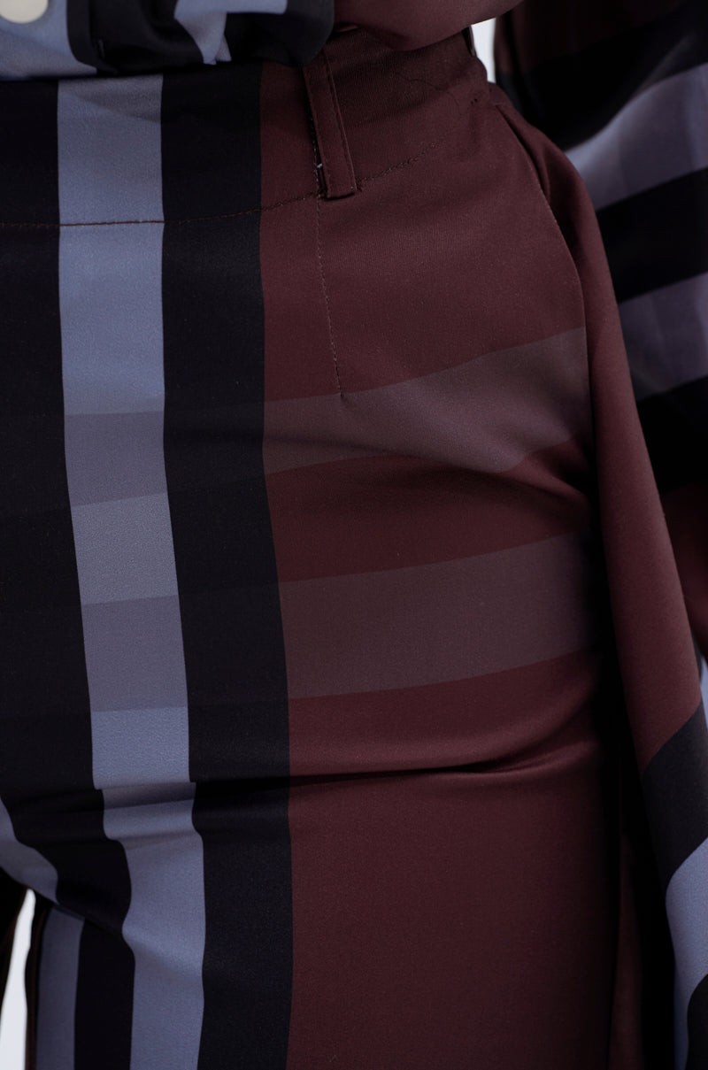 Close-up of the LUXURY LIFE PLAID PALAZZO PANT, featuring a high-rise wide-leg design with a vertical striped pattern in dark brown, black, and grayish blue. The smooth fabric has a slight sheen.
