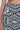 A close-up showcases a person in a VACA MODE ABSTRACT MAXI SKIRT with a high-rise design and bold B&W geometric print. It features an array of shapes like triangles, squares, and circles for a striking visual effect.