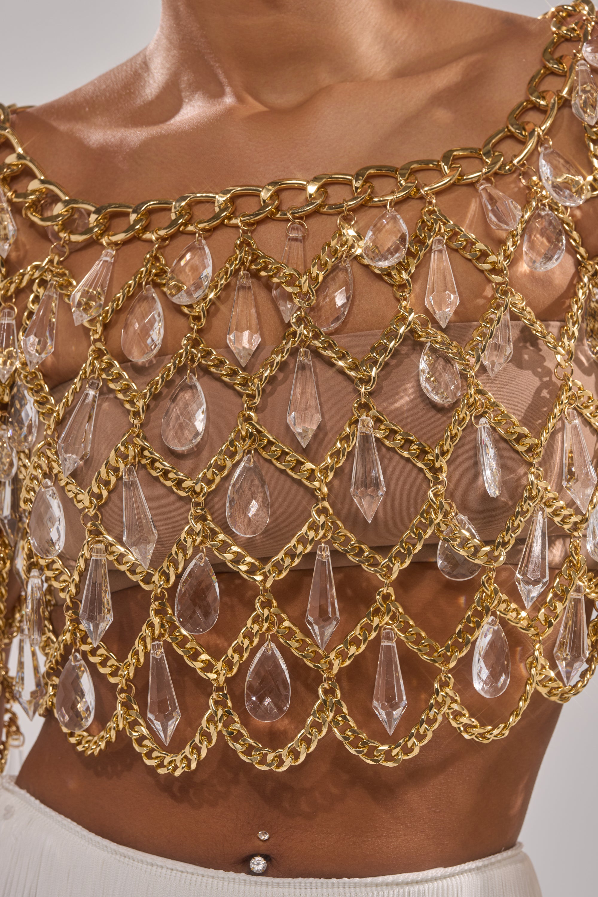 A close-up of the GLAM BABY CHAIN TOP featuring large clear crystal teardrop embellishments and an intricate lattice design for a dazzling, jewelry-like effect when worn over bare skin. 7