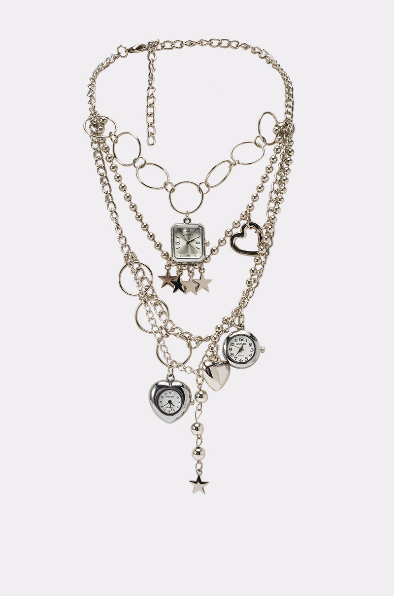 Introducing the CLOCK NECKLACE—a striking streetwear accessory featuring layered silver chains adorned with assorted charms, including a square watch face, heart-shaped accents, star motifs, and a small round clock. This unique piece is perfectly designed for festival jewelry style.