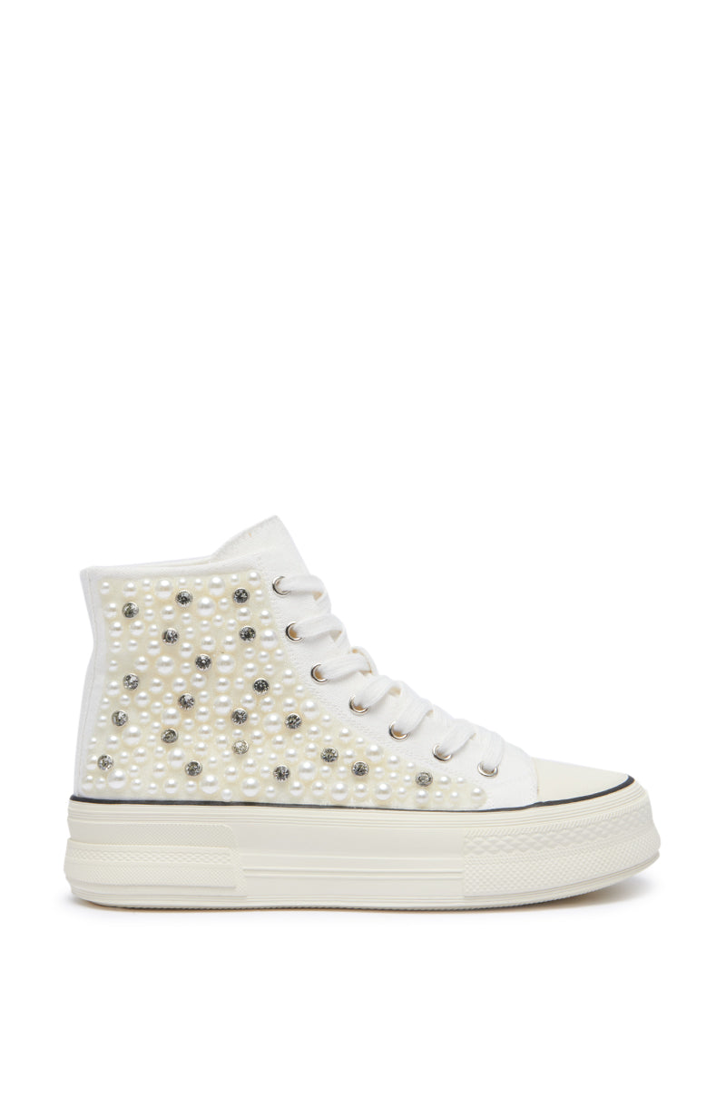 The AZALEA WANG SAISHA PEARL WHITE SNEAKER features a striking high-top design with a thick sole and is adorned with silver stud embellishments. The side and upper portions are densely decorated with these small details, adding texture and shine to the embellished shoe. The laces and toe cap are also white, completing this stunning design.