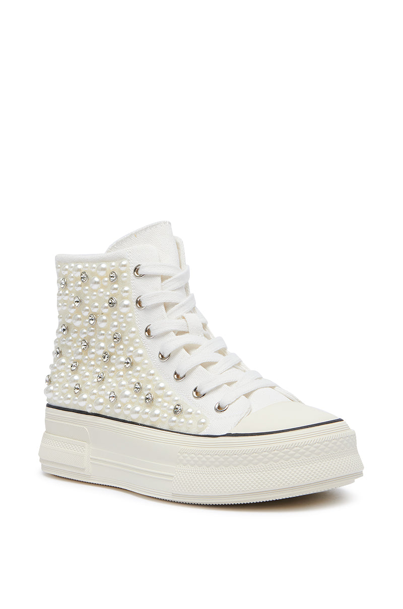 The AZALEA WANG SAISHA PEARL WHITE SNEAKER is a high-top sneaker with a chunky rubber sole, complete with metallic eyelets and white laces. The sides and heel are adorned with numerous small, pearl-like embellishments, making it the perfect pair of embellished shoes for any fashion-forward individual.