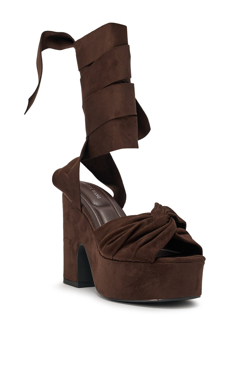 The AZALEA WANG SAKI CHOCOLATE CHUNKY WRAP UP SANDAL features faux suede, a high block heel, knotted toe strap detail, and a wide wraparound ankle tie ribbon for standout style. 4