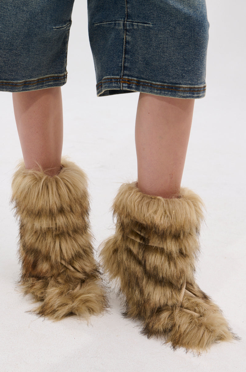 Only the lower legs and feet are visible, showing someone wearing knee-length denim shorts and AZALEA WANG SALERE BROWN ROPE DETAIL STILETTO BOOTIE while standing on a white surface.
