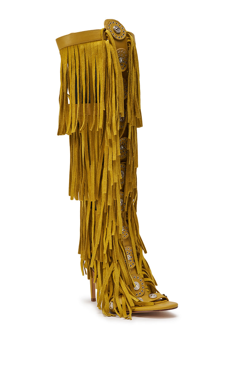 The AZALEA WANG SAMEYANA MUSTARD FRINGE AND METAL STILETTO GLADIATOR SANDAL features mustard faux suede, knee-high fringe, and bold silver studs for a striking western-inspired look. 4