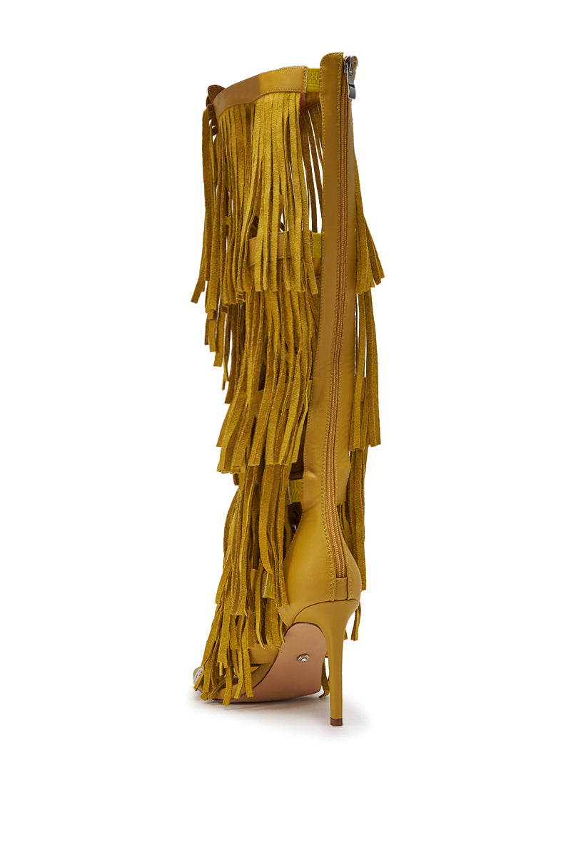 The AZALEA WANG SAMEYANA Mustard Fringe and Metal Stiletto Gladiator Sandal features yellow knee-high design, multiple layers of long fringe, an inner zipper, and a high, thin heel, shown from the side. 5