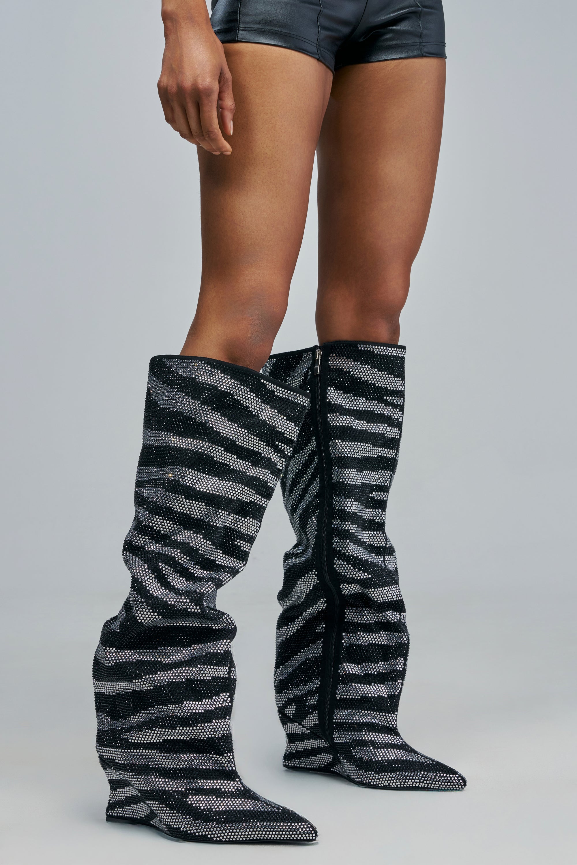 AZALEA WANG SANCHIAX RHINESTONE ZEBRA WEDGE BOOT: a pair of knee-high wedge boots covered in a black and silver zebra rhinestone pattern.