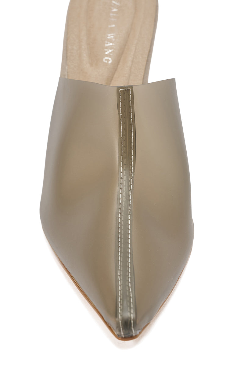 A close-up view of the AKIRA GOLD SANCTUS GREY PVC PUMP, featuring a pointed toe and slip-on style with a visible seam running down the center of the upper.