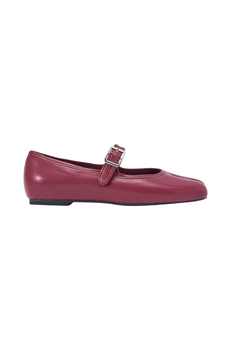A single AKIRA GOLD SANG BURGUNDY PU SPLIT TOE FLAT in maroon with a low heel, rounded split toe, and a strap across the top secured by a small silver buckle. 3