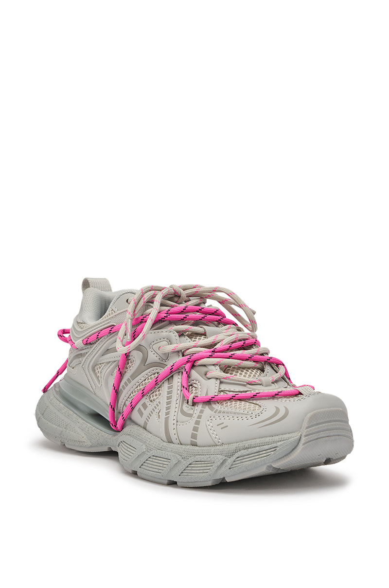 The AZALEA WANG SATINE GREY LACE UP SNEAKER is a light gray statement shoe with an intricate design and bright pink laces wrapped around it, shown from the front against a white background. 6