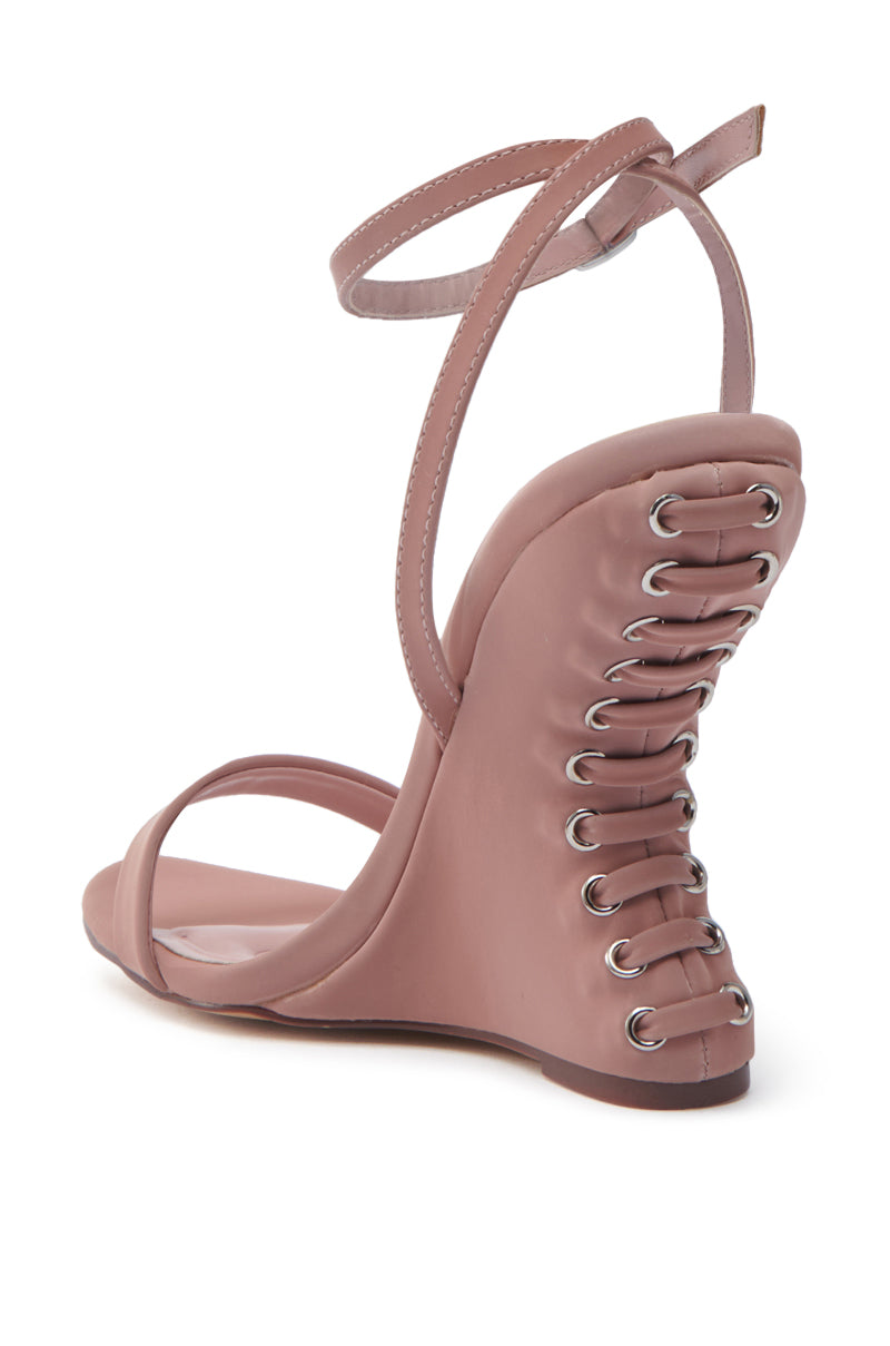 The AZALEA WANG SAWNEY MAUVE LACE UP PATENT SANDAL features a pink faux leather lace-up design with a unique back. Its corset-style wedge heel has crisscross laces through silver eyelets, paired with thin ankle and toe straps for elegance.