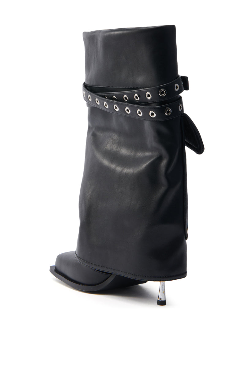 The AZALEA WANG SAYLAH BLACK FOLD OVER STILETTO BOOTIE is a chic black faux leather bootie with a slouchy shaft, strap with metallic eyelets, pointed toe, and stiletto heel.
