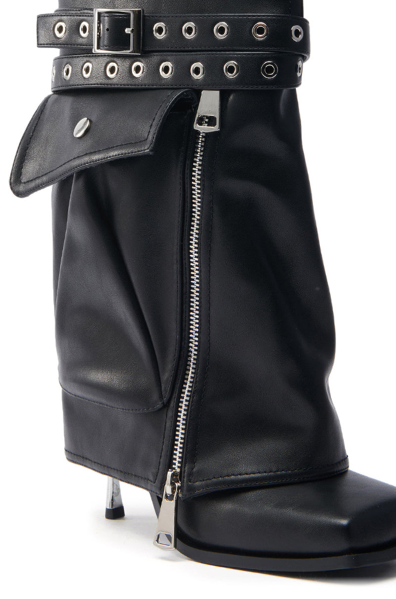 The AZALEA WANG SAYLAH BLACK FOLD OVER STILETTO BOOTIE is a black faux leather bootie with a wide slouchy cuff, decorative buckle and eyelets, a shiny silver side zipper, button-flap detail, and a sleek metallic stiletto heel for an elegant modern look.