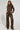 A person with long braided hair stands confidently, showcasing the 