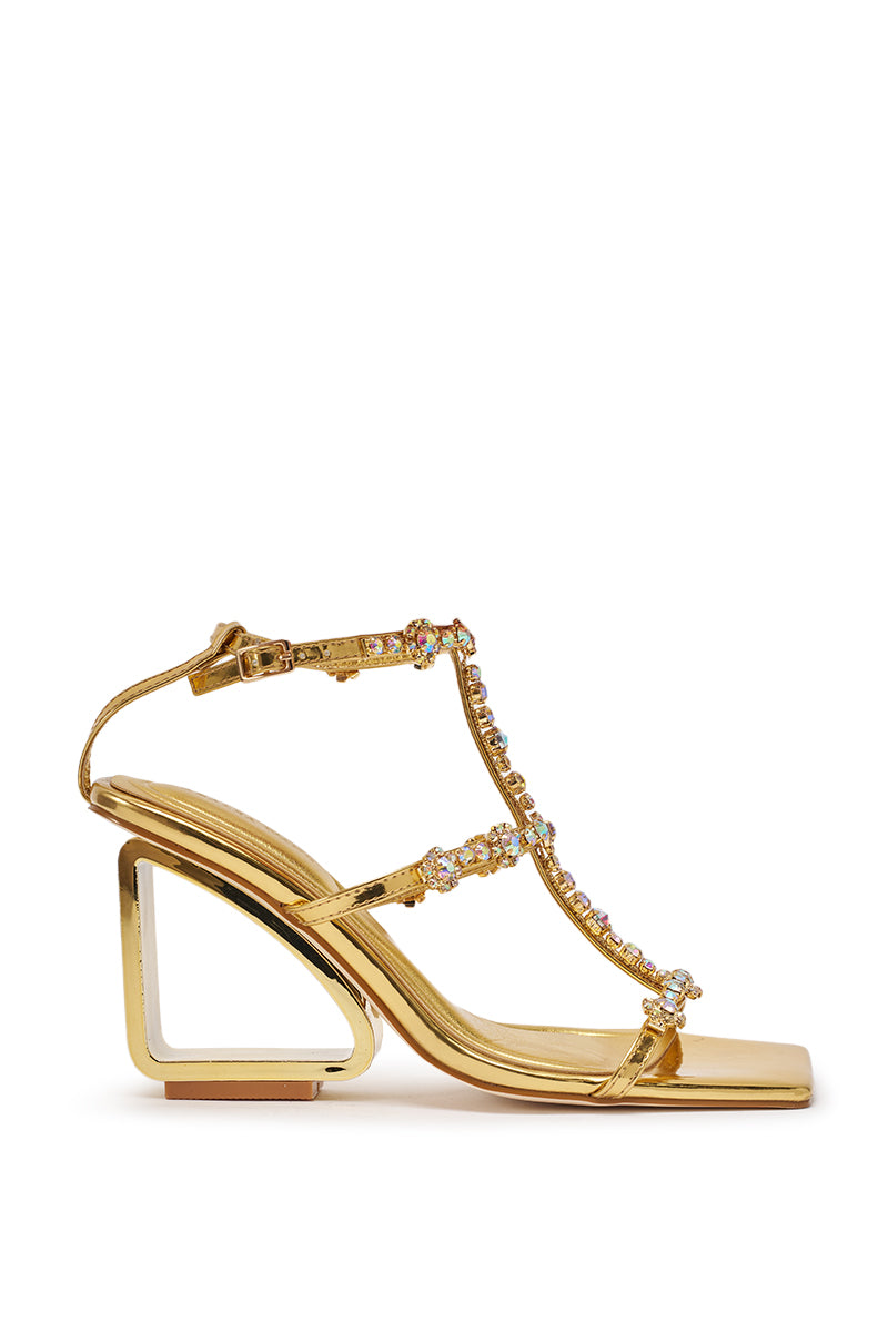 The AZALEA WANG SCHANTELLE Gold Embellished Upper Wedge Sandal features rhinestone-adorned straps, a metallic finish, geometric wedge heels, and an ankle buckle closure, elegantly displayed on a white background. 3