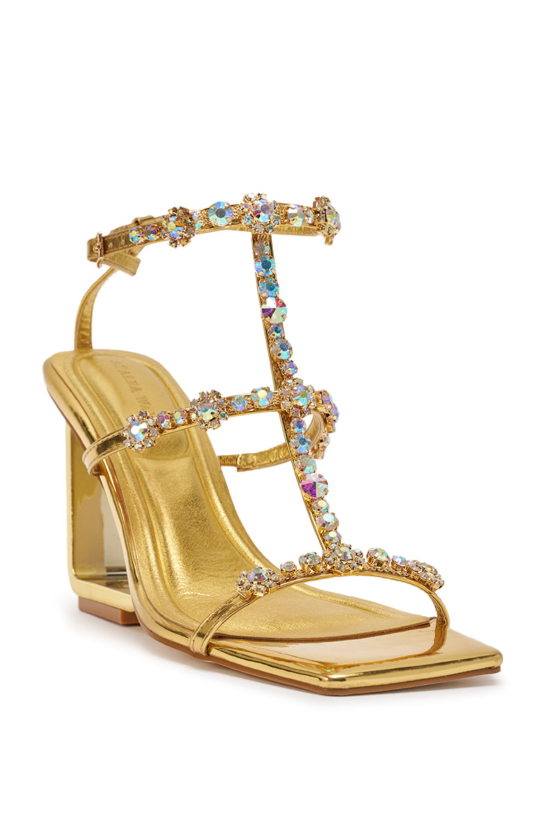 The AZALEA WANG SCHANTELLE Gold Embellished Upper Wedge Sandal features a square toe, multiple multicolored gemstone straps, and a chunky metallic gold wedge heel for an eye-catching, sparkling finish. 5