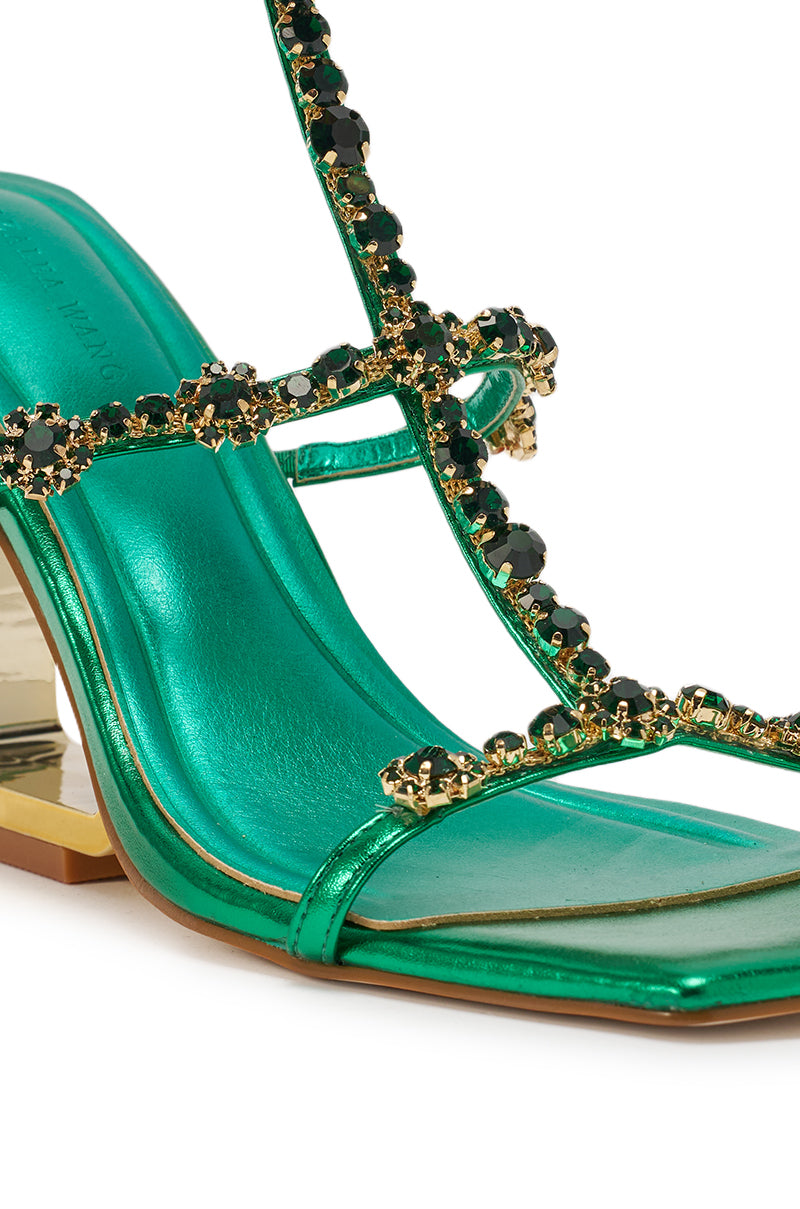 A close-up of the AZALEA WANG SCHANTELLE Green Wedge Sandal, featuring a metallic green finish, rhinestone embellished straps, a square toe, and a bold wedge heel. 5