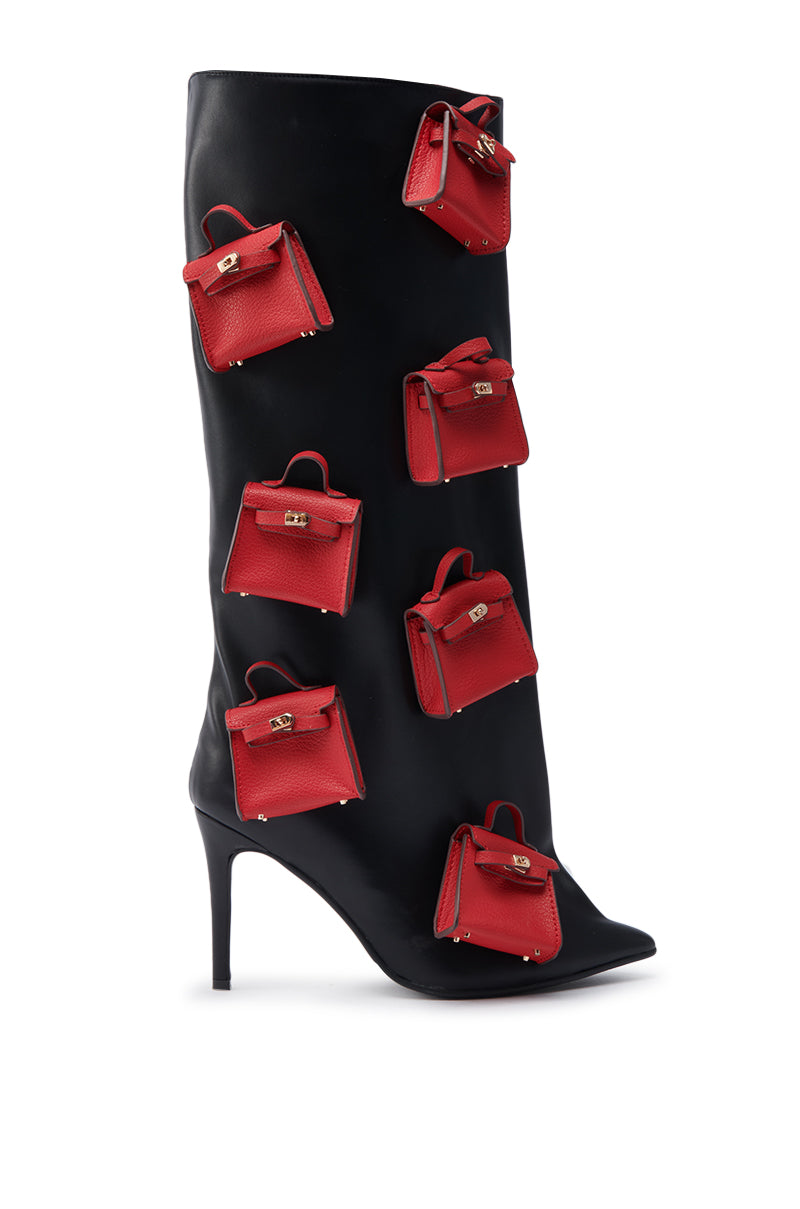 The AZALEA WANG SCIPIO BLACK PURSE BOOT is a black stiletto heel knee-high boot embellished with multiple small red handbag appliqués across its surface.