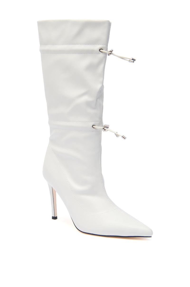 The AZALEA WANG SEANNA IVORY CINCHED STILETTO BOOTIE is a white faux leather mid-calf boot featuring a pointed toe, slim stiletto heel, and two adjustable drawstring closures on the calf shaft. 2
