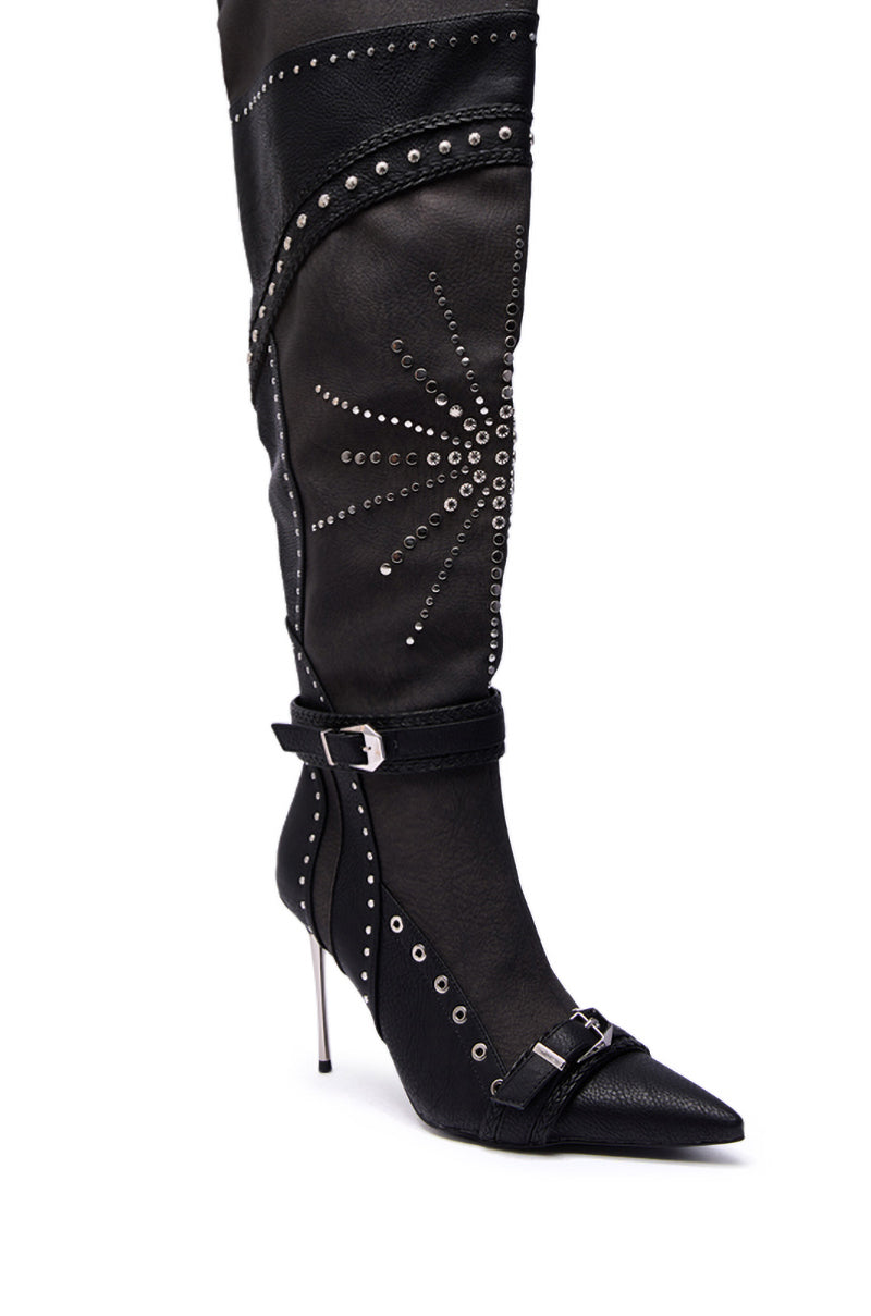 The AZALEA WANG SEASON BLACK MULTI EMBELLISHED STILETTO BOOT is a black, knee-high boot featuring silver starburst and linear stud patterns, a pointed toe, and two silver buckles—one at the ankle and one above the foot.