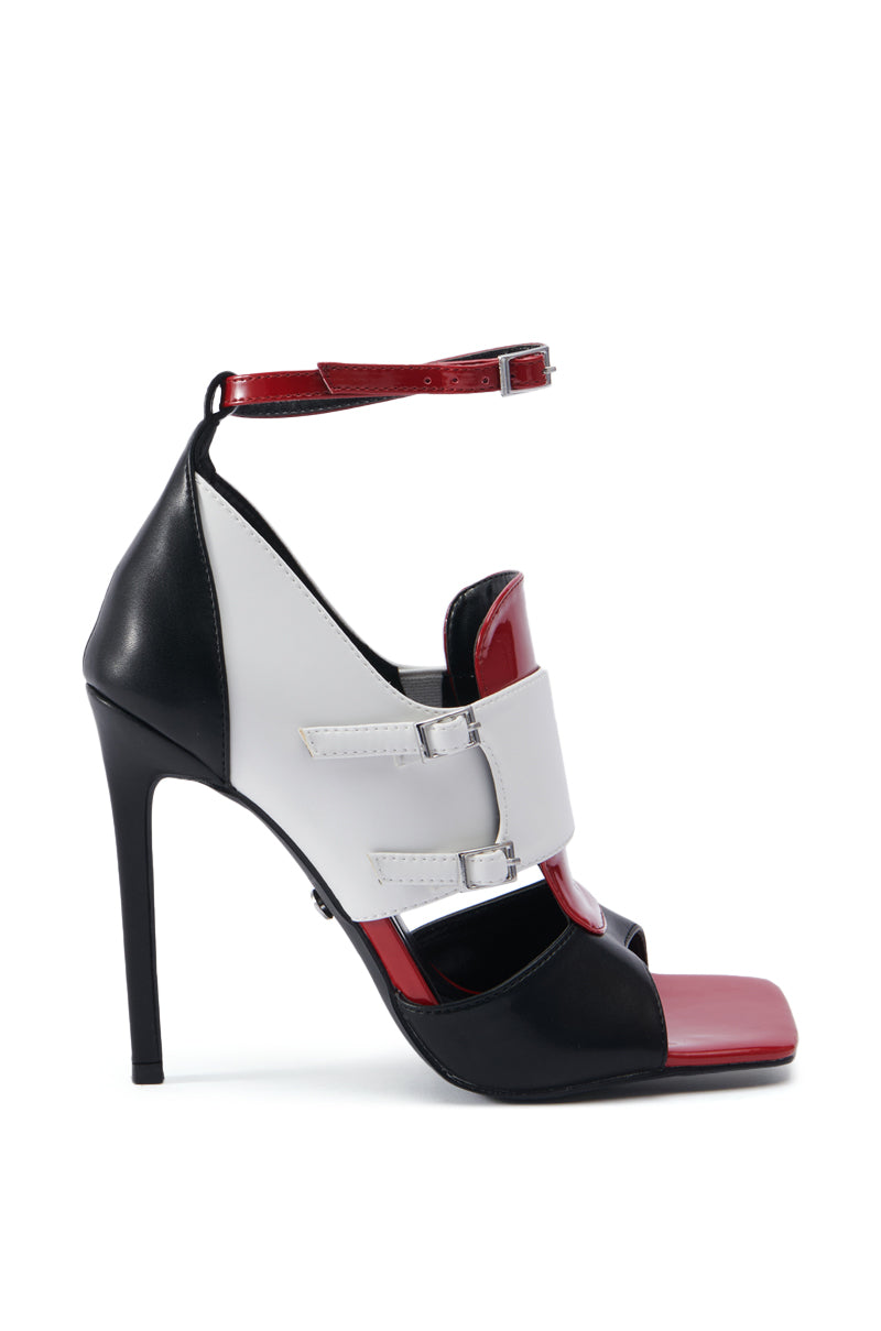 Introducing the AZALEA WANG SELEENER RED SPORTY SANDAL, a high-heeled sandal that boasts a striking color-block design in red, black, and white. This shoe features a buckle strap around the ankle, a closed heel, and an open toe with a stylish strap across the top of the foot. The stiletto heel and geometric details enhance its modern aesthetic.