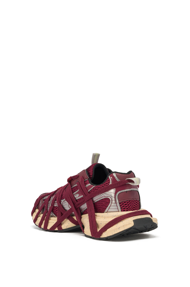 The AZALEA WANG SELIE BURGUNDY LACE UP SNEAKER features maroon and beige chunky styling, decorative crisscross details, and mesh panels, shown from the back left angle on a plain white background. 4