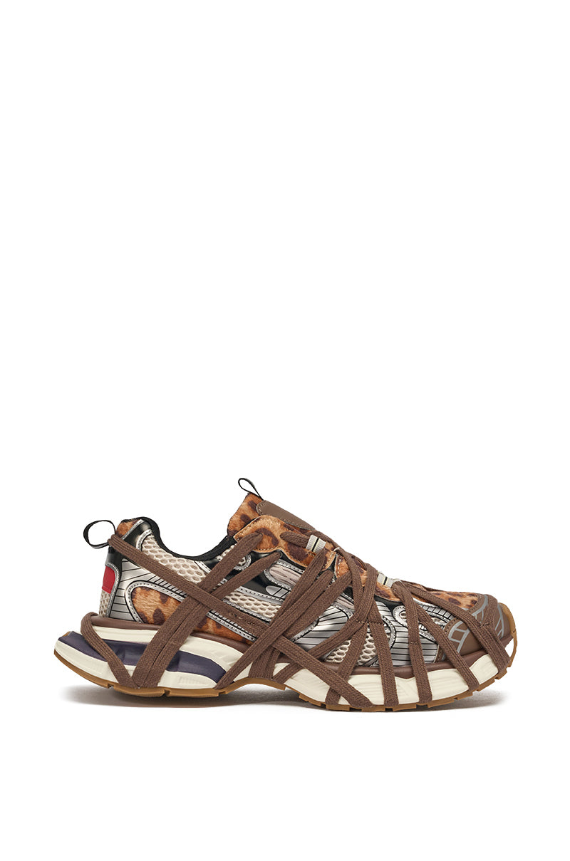 The AZALEA WANG SELIE LEOPARD PRINT LACE UP SNEAKER features lace details, a leopard print upper, brown crisscross straps, and a chunky sole with beige, navy, and white accents. 2