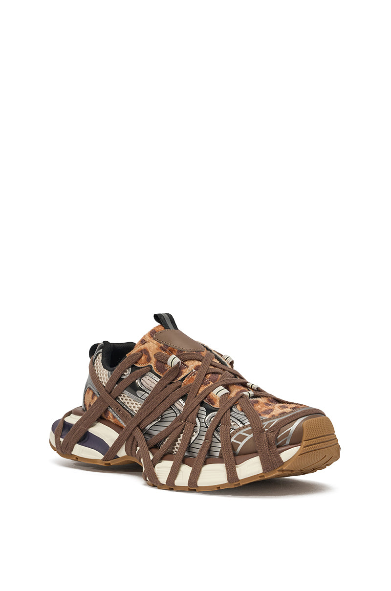 The AZALEA WANG SELIE LEOPARD PRINT LACE UP SNEAKER features a chunky brown sole, beige and brown cheetah print upper, black and white accents, and multiple crisscrossing brown straps. 3