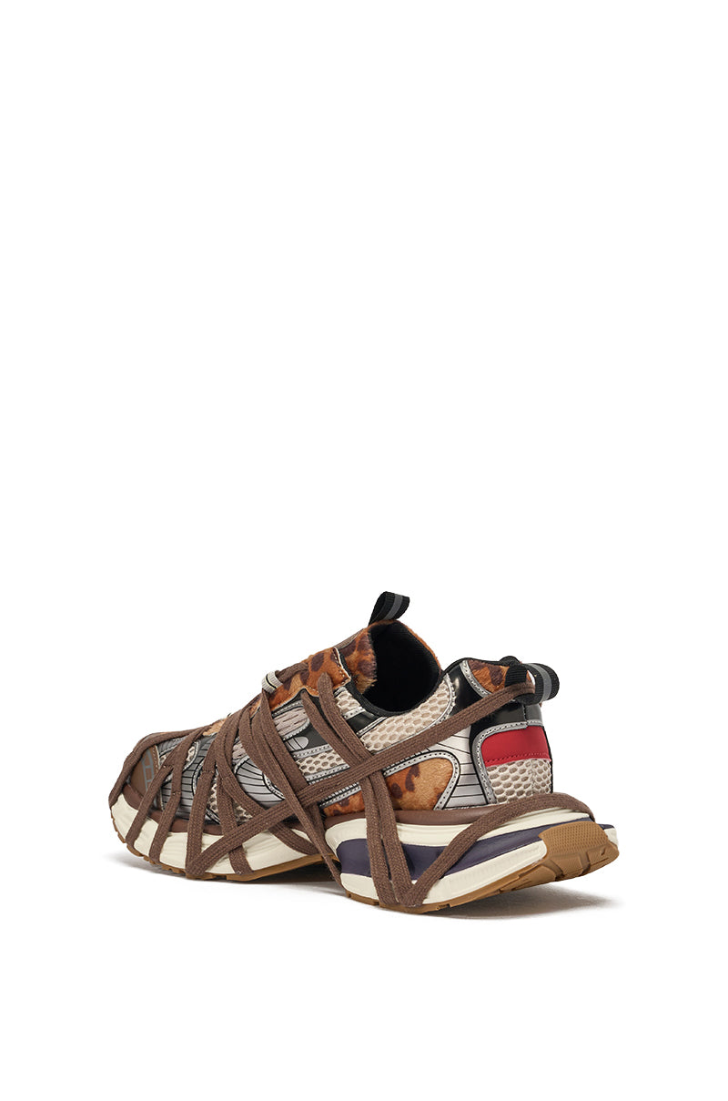The AZALEA WANG SELIE LEOPARD PRINT LACE UP SNEAKER features a chunky design in brown, beige, and white with crisscrossing straps and patterned uppers, displayed from a rear side angle on a white background. 4