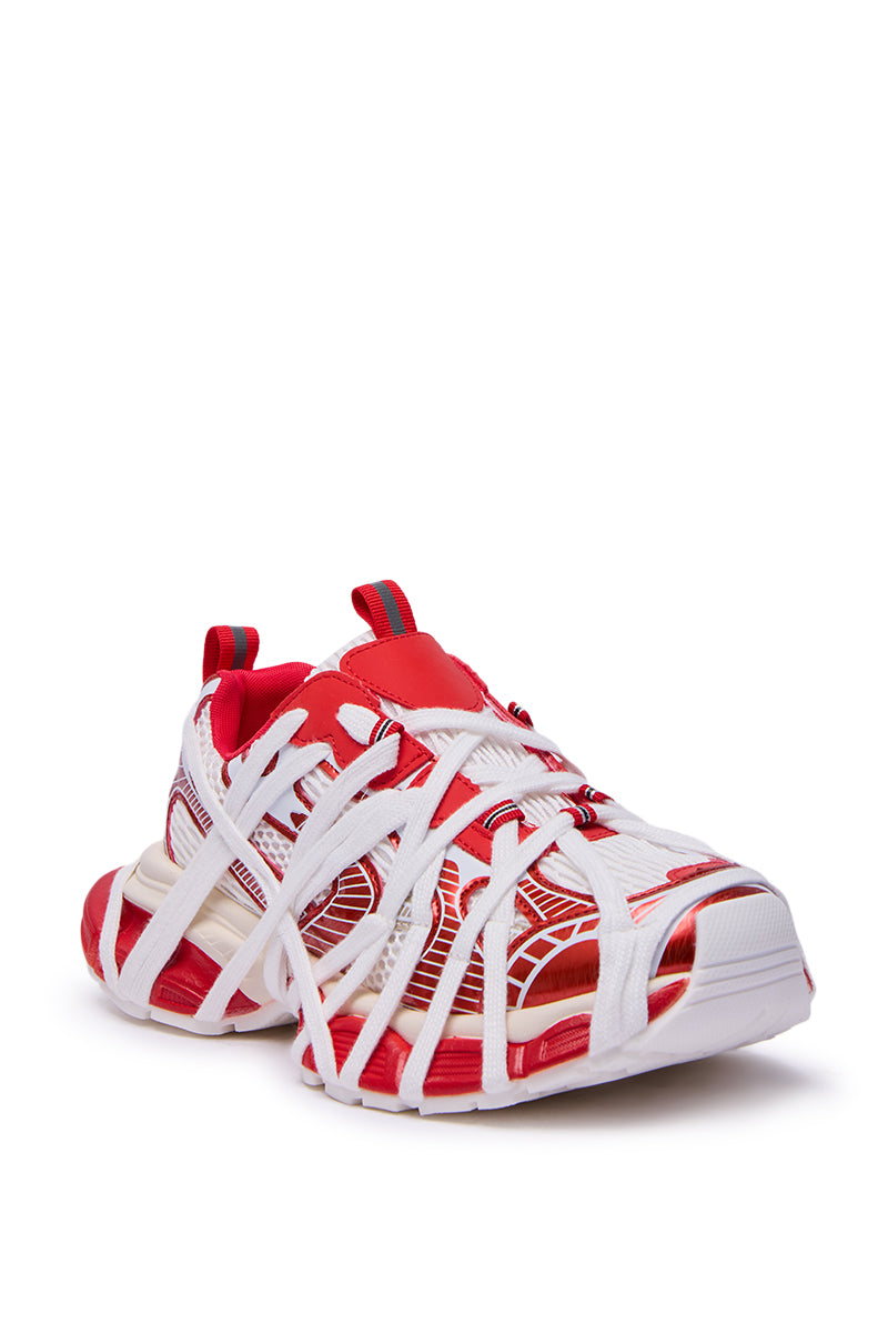 The AZALEA WANG SELIE RED FLAT SNEAKER is a slip-on with a chunky sole, bold red accents on the tongue and heel, and a unique cage-like white strap design wrapping around its red and white upper.