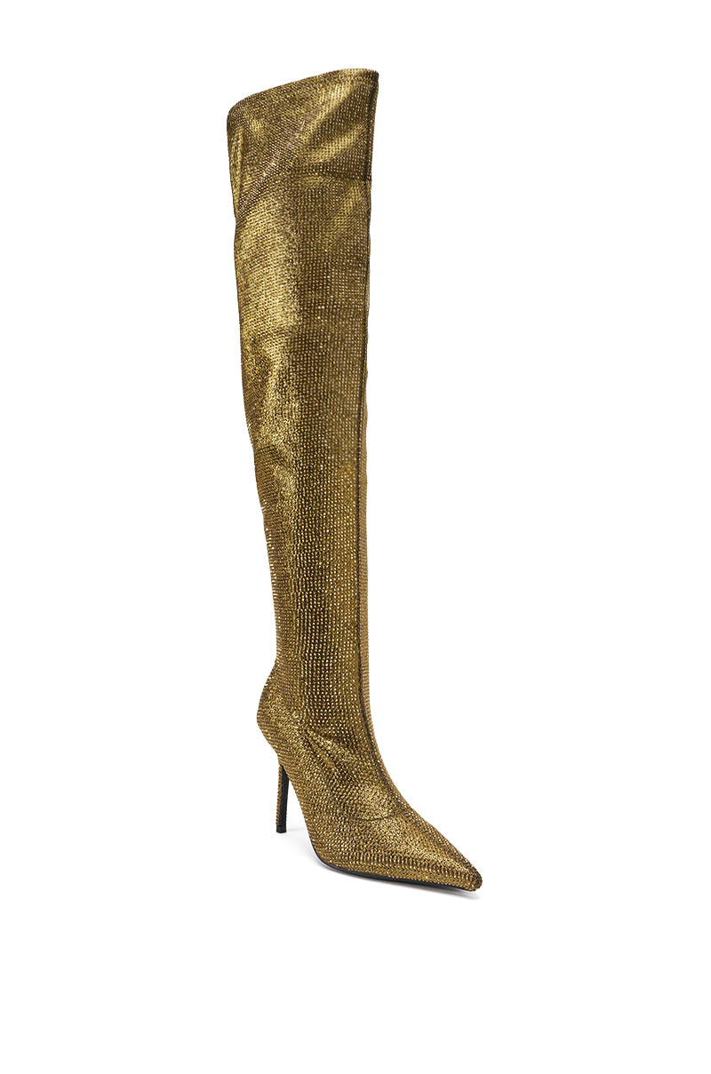 The AKIRA GOLD SELMA GOLD SPARKLE OVER THE KNEE BOOT dazzles with shimmering rhinestones, a pointed toe, and a bold stiletto heel—perfect for anyone seeking eye-catching gold rhinestone thigh high boots.