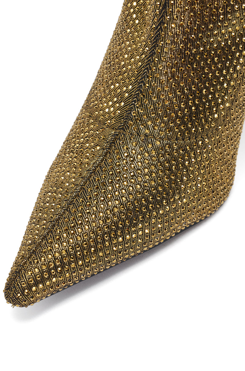 Close-up of the pointed toe of the AKIRA GOLD SELMA GOLD SPARKLE OVER THE KNEE BOOT, featuring gold metallic texture with woven and studded details.