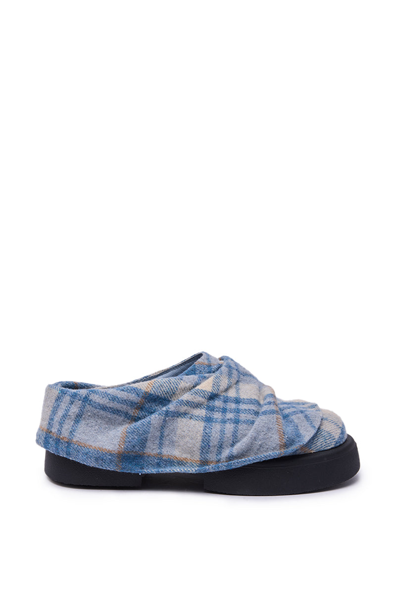 The AZALEA WANG SEYMON Blue Multi Plaid Slip-On Ruched Flat features a blue and gray plaid pattern, soft folded design, and thick black sole, shown from the side against a white background. 3