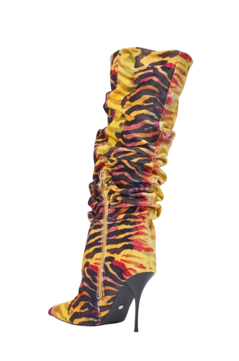 The AZALEA WANG SERIOUSLY TIGER SLOUCHY STILETTO BOOT is a knee-high, pointed toe stiletto boot featuring a bold yellow, black, and red tiger print with a gathered slouchy design. 5