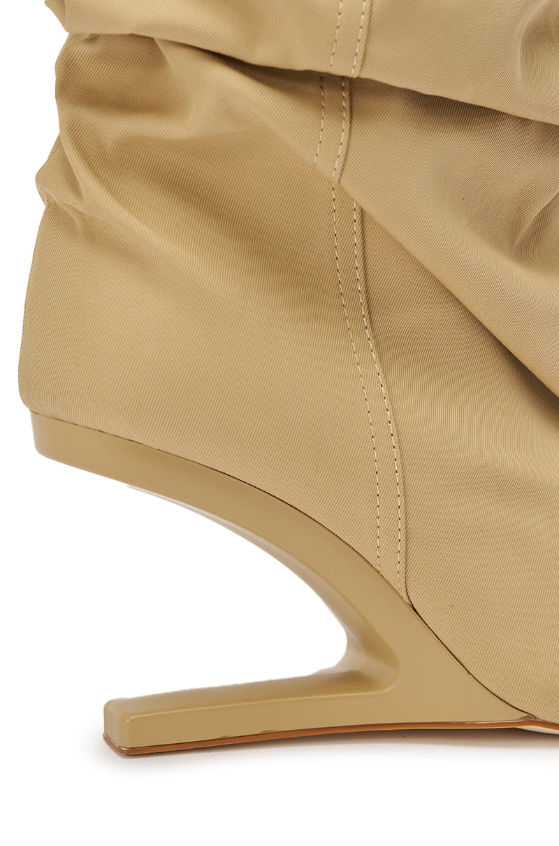 Close-up of the AZALEA WANG SERONA KHAKI INVISIBLE WEDGE BOOTIE, featuring a unique angular heel that curves inward, ruched fabric detail, and smooth structured material for standout style. 5