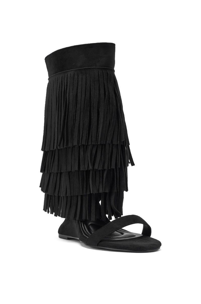 The AKIRA GOLD SESTINA Black Faux Suede Fringe Wedge Sandal features an open toe, faux suede material, layered fringe up the calf, a wedge sole, and a wide ankle cuff for a bold boho-chic style. 4