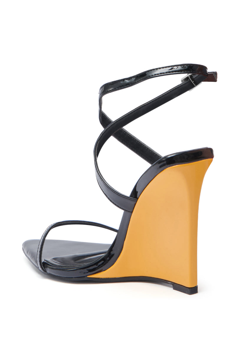 The AZALEA WANG SEUNG Black Color Blocked Heel Wedge Sandal features glossy black faux leather straps, an open pointed toe, and a bold yellow wedge heel, shown against a white background.