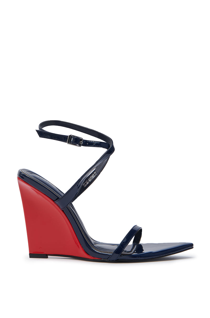 The AZALEA WANG SEUNG NAVY MULTI RED WEDGE HEEL SANDAL features navy blue faux patent leather straps, an ankle buckle strap, and a striking red wedge heel, shown against a white background.