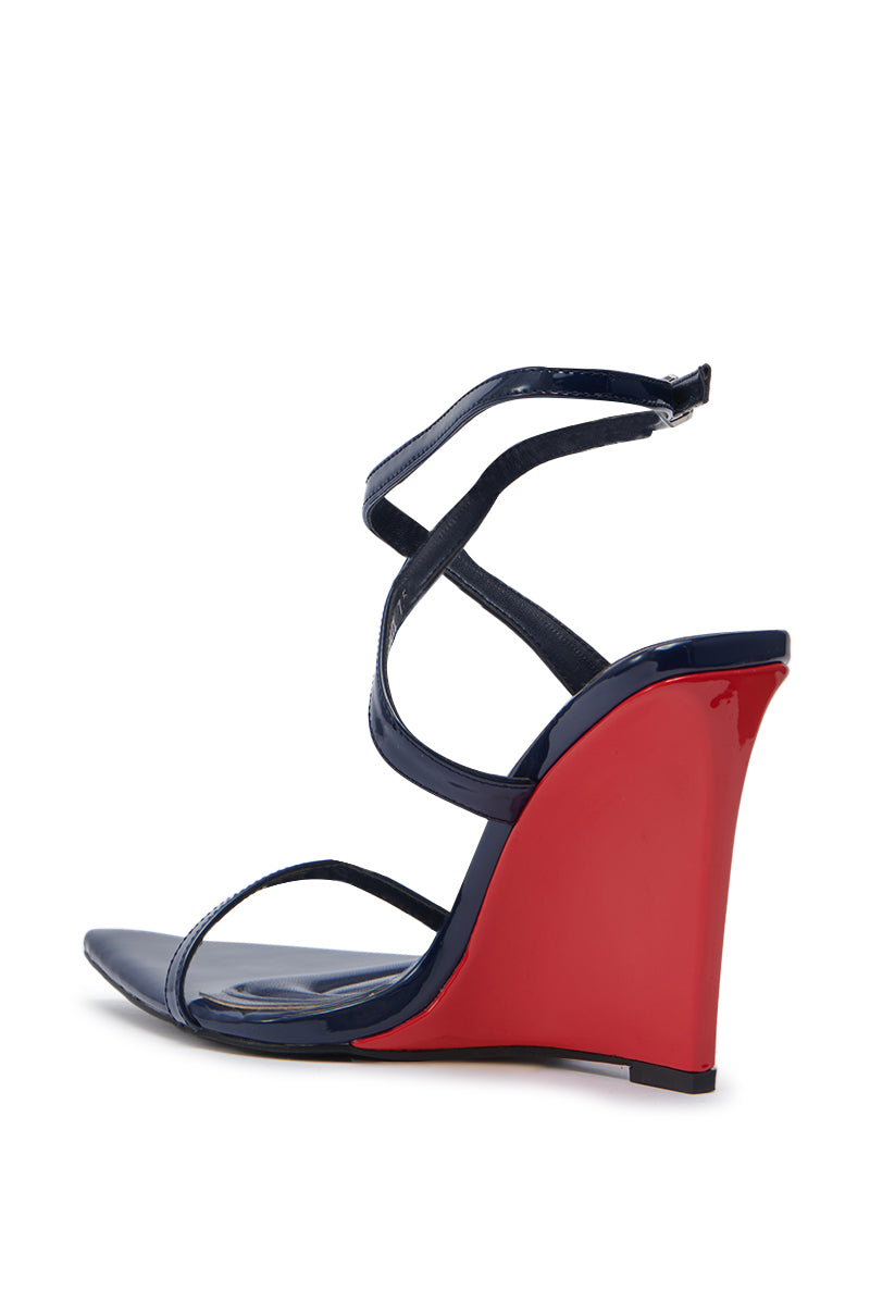 The AZALEA WANG SEUNG Navy Multi Red Wedge Heel Sandal is crafted from faux patent leather and features a high glossy red wedge, strappy design, comfort cushion insole, and secure ankle strap—shown on a white background.