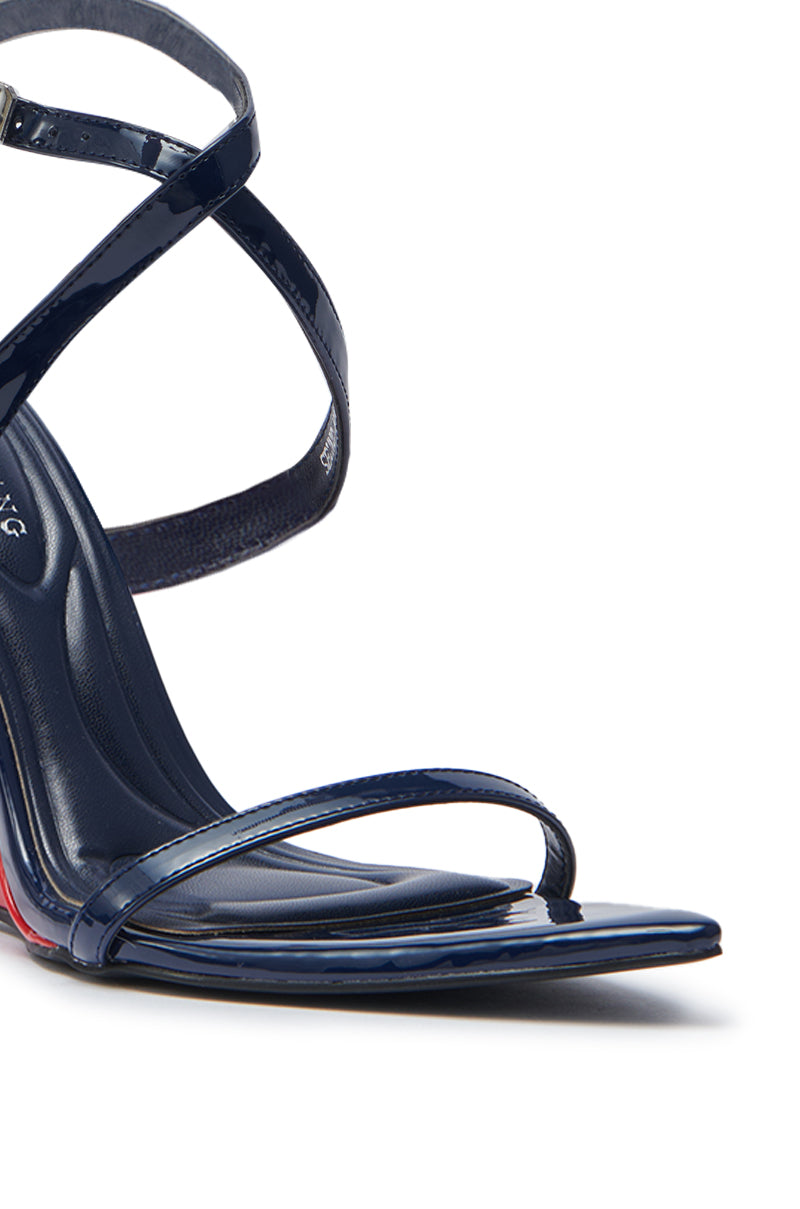 Side view of the AZALEA WANG SEUNG Navy Multi Red wedge heel sandal in dark blue faux patent leather, featuring glossy straps and an ankle buckle, set against a white background.