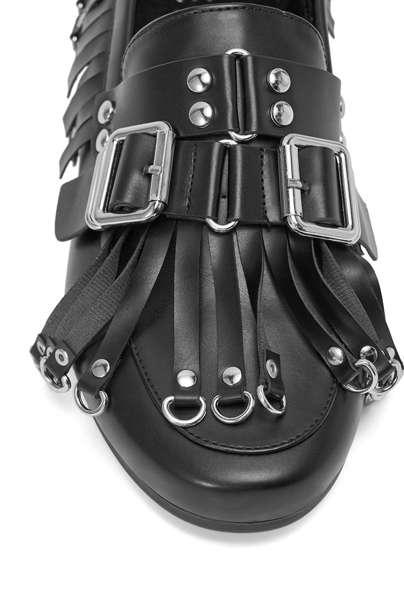 Close-up of the AZALEA WANG SEVYN BLACK WITH SILVER HARDWARE FLAT LOAFER, showcasing decorative silver buckles, studs, metal rings, and leather fringe on the toe for a bold blend of metallic and faux leather style. 6