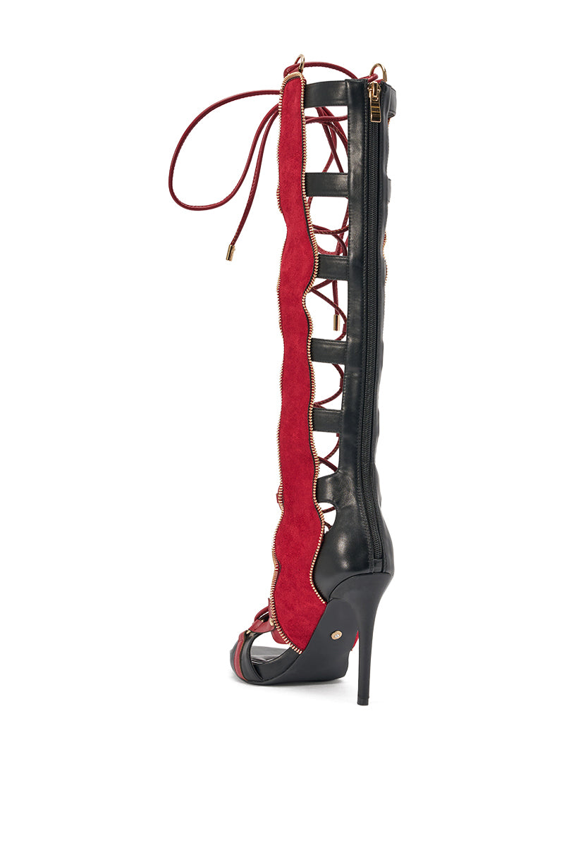 The AZALEA WANG SHAI BLACK MULTI GLADIATOR SANDAL features stiletto heels, red suede accents, open sides, lace-up details, and a back zipper—ideal for making a bold style statement.