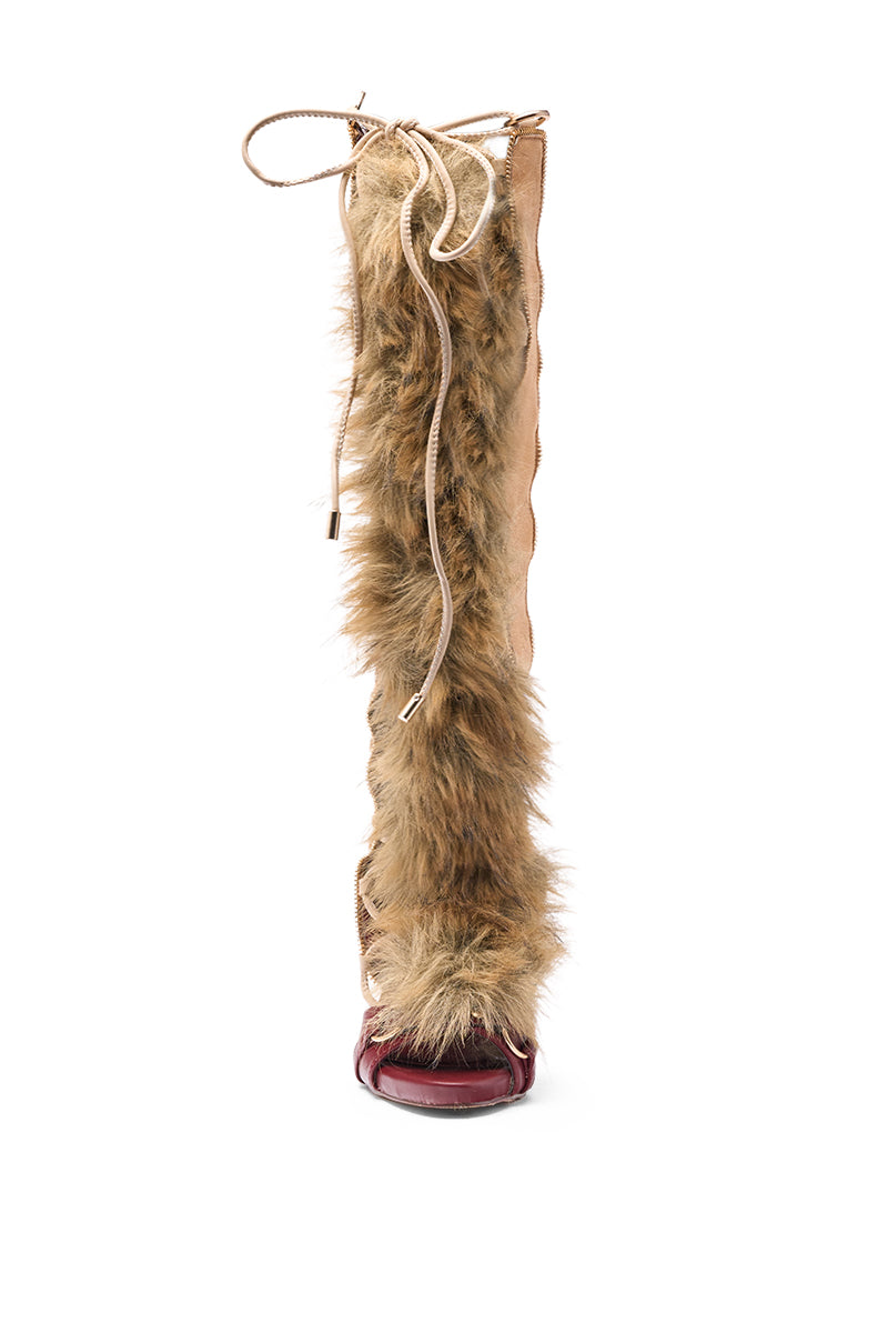 The AZALEA WANG SHAINE MULTI GLADIATOR STITCH AND FUR SANDAL features knee-high design, brown faux fur front, tan side fabric, lace-up top closure, burgundy faux fur heel, and an open toe.