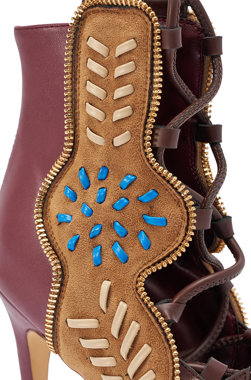 The AZALEA WANG SHAINIA PLUM MULTI FAUX SUEDE STILETTO SANDAL features plum suede, burgundy leather, tan and brown details, a gold zipper trim, plus cream and blue accents.