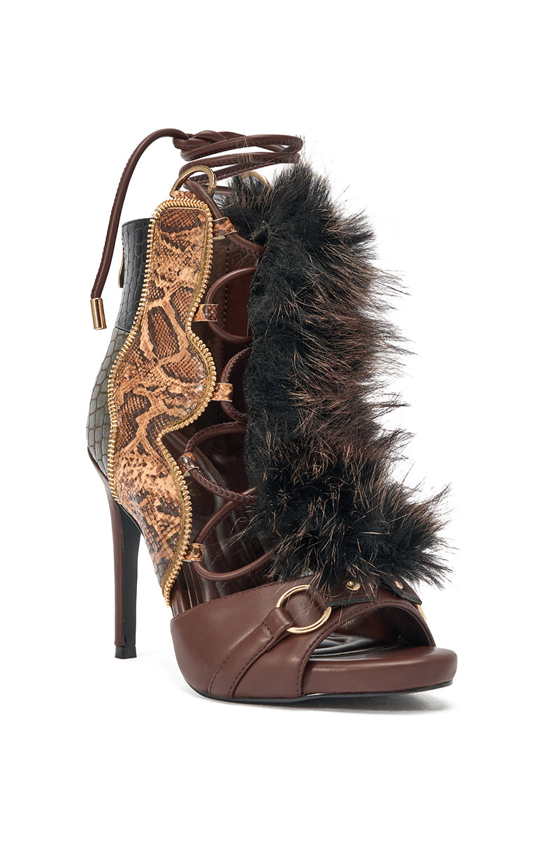 The AZALEA WANG SHAINY SNAKE BROWN MULTI is a lace-up open-toe sandal with brown leather, faux snakeskin accents, black faux fur trim, gold hardware, and an ankle-high heel for standout style. 3