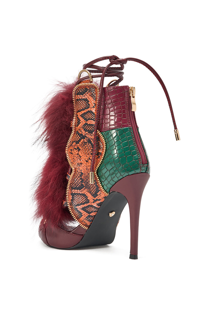 The AZALEA WANG SHAINY SNAKE BURGUNDY MULTI is a stiletto featuring maroon, green, and orange faux snakeskin, a burgundy heel, faux fur trim, gold zipper, and lace-up detail. 4