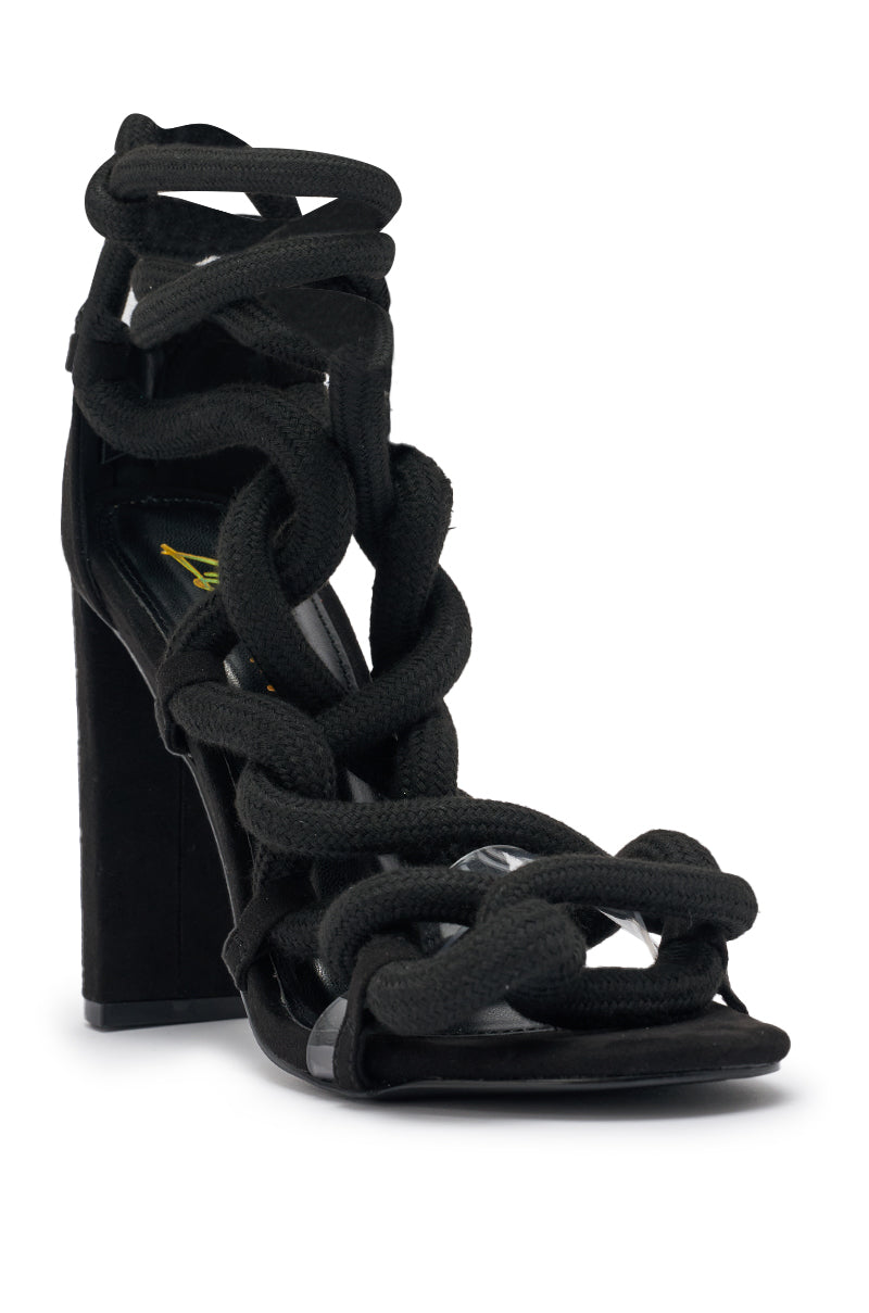 Make a statement in the AKIRA GOLD BLACK ROPE STRAP STILETTO SANDAL, featuring thick black rope straps laced across the foot and ankle, an open toe, and a bold stiletto heel. 5