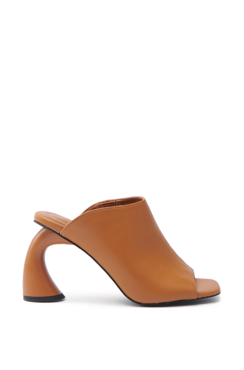 The AZALEA WANG Tan Slip-On Mule Sandal is a vegan leather, open-toed design featuring a minimalist upper and glossy finish. Its unique sculptural heel boasts a loop shape for an artistic touch, delivering a sleek and modern look.