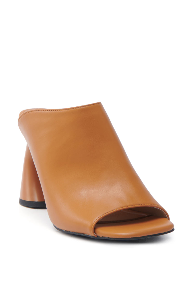 The AZALEA WANG TAN SLIP ON MULE SANDAL is a tan, slip-on mule with a high, chunky heel against a white background, showcasing a smooth vegan leather finish and a modern minimalist design.