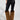 The person wears SIREN FUR TRIM FAUX LEATHER PANTS along with brown faux fur leg warmers and black pointed-toe high-heeled shoes. The image focuses on their lower body against a plain background.